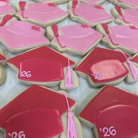 Dark pink grad cap cookie