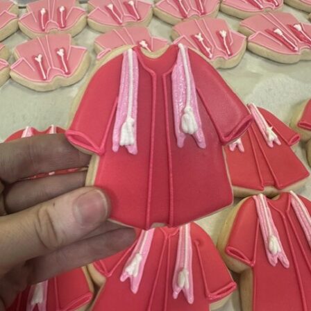 Dark pink grad gown cookie